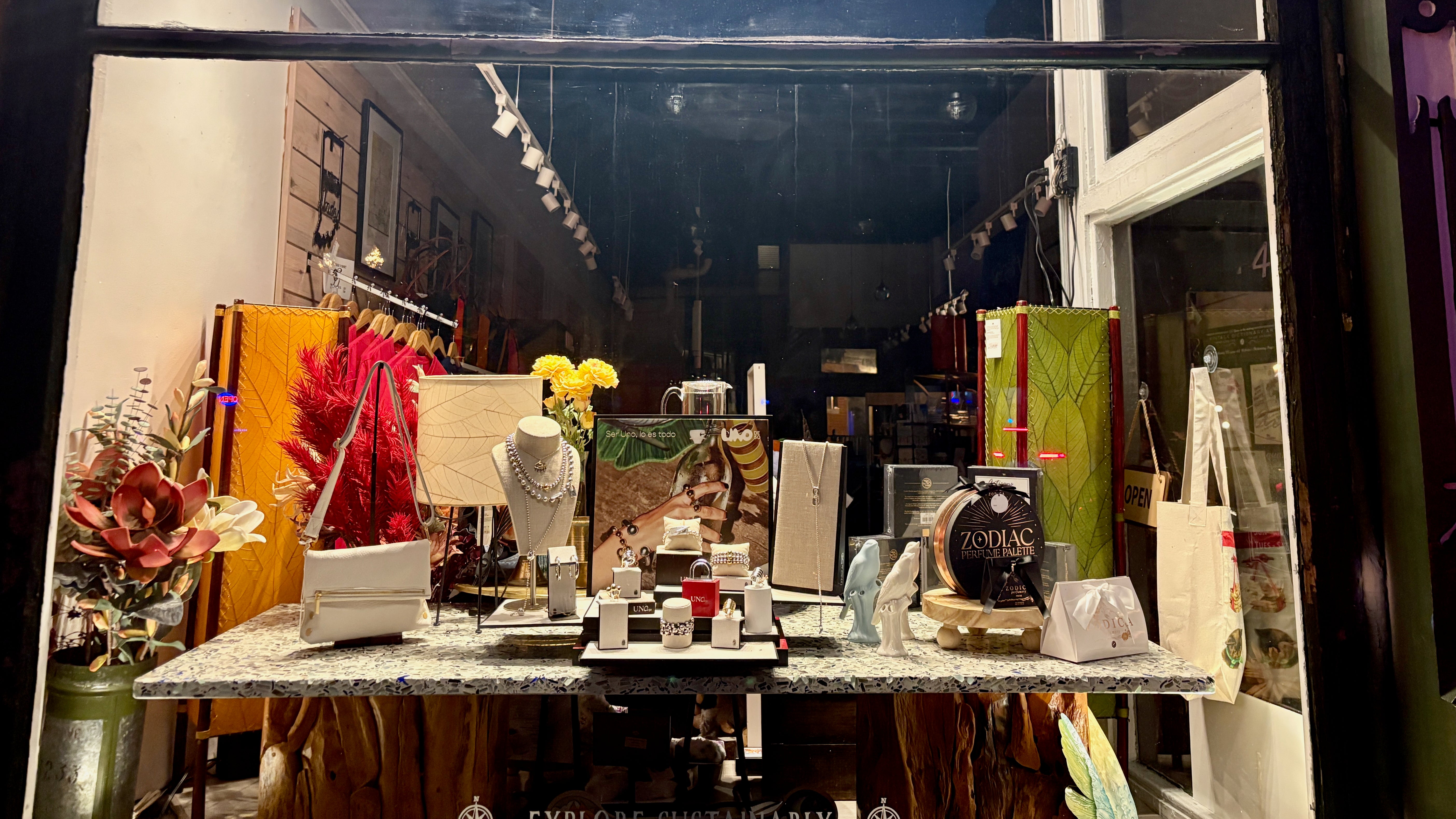 Display of jewelry and decorative items in a store window.