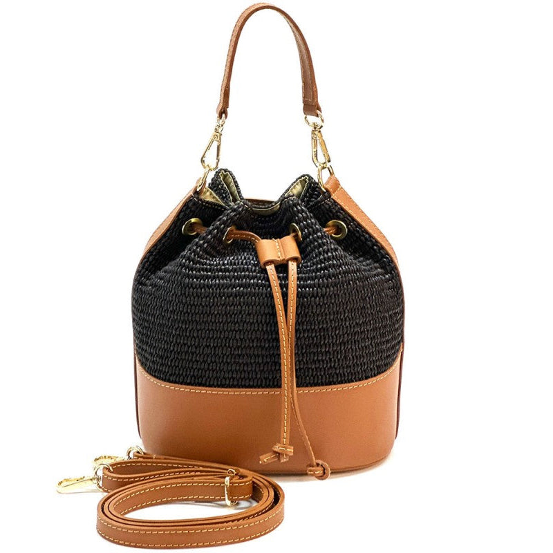 Black and brown bucket bag with a strap on a white background