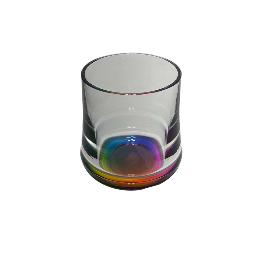 Clear glass with rainbow-colored base on a white background